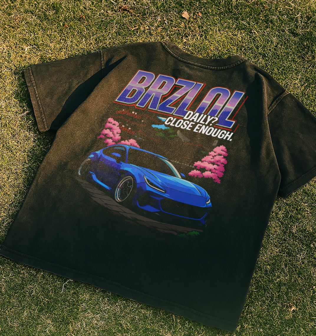 Black t-shirt with a blue car graphic and 'BRZOL' text on grass