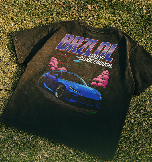 Black t-shirt with a blue car graphic and 'BRZOL' text on grass